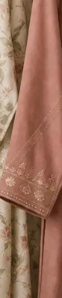 Close-up of hand-embroidered dusty rose fabric border